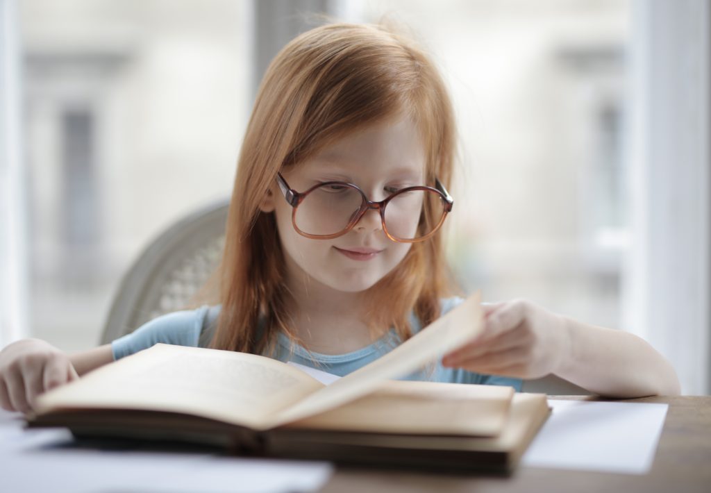 girl-reading-a-book-with-eyeglasses-3887454-1024x710