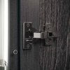 Detail kovania nábytku z kolekcie KRYSTAL. Ónyxové lesklé pánty s mäkkým zatváraním, ktoré môže byť deaktivované, podľa uváženia klienta, tak, aby bolo dosiahnuté požadované tempo zatvárania.