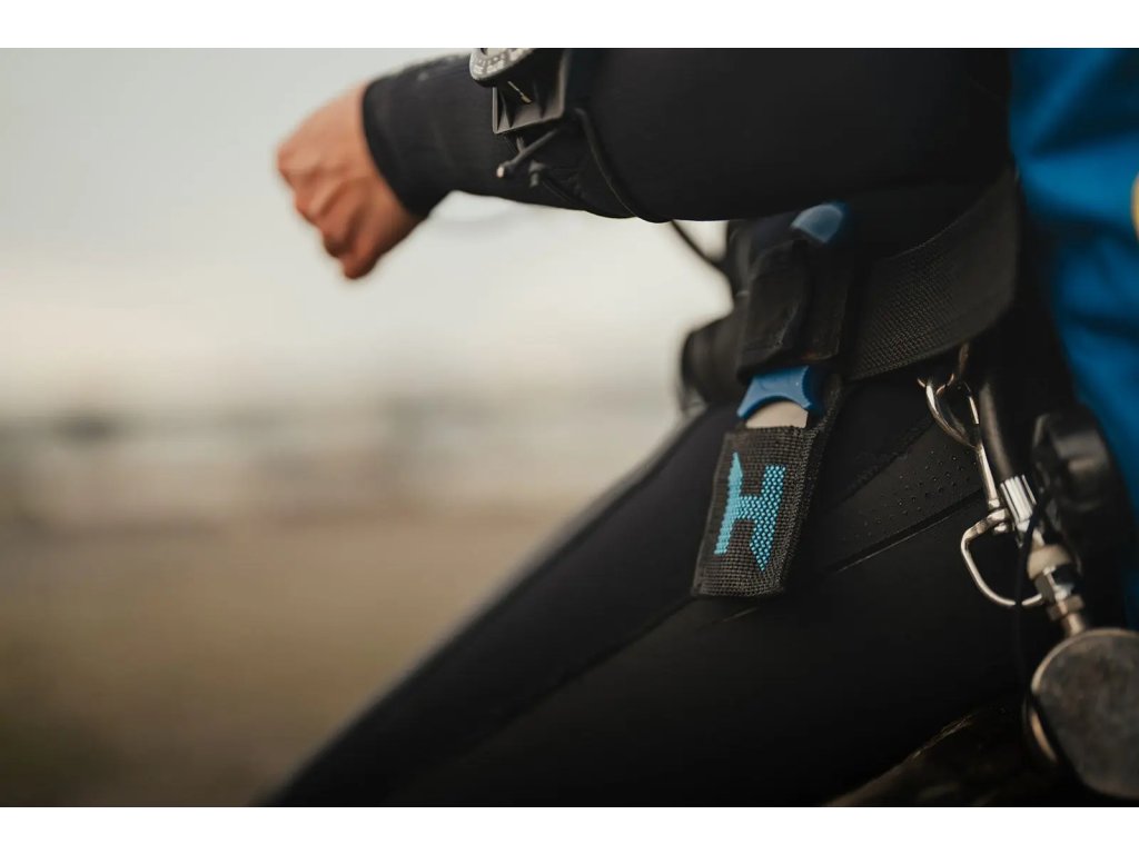 Praktická aplikácia na 50mm bedrovom popruhu postroja; nízkoprofilové textilné puzdro minimalizuje riziko zachytenia.