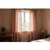 Soft, patterned curtains in a sun drenched bohemian bedroom, natural light streaming through the window, highlighting the intricate patterns of the fabr