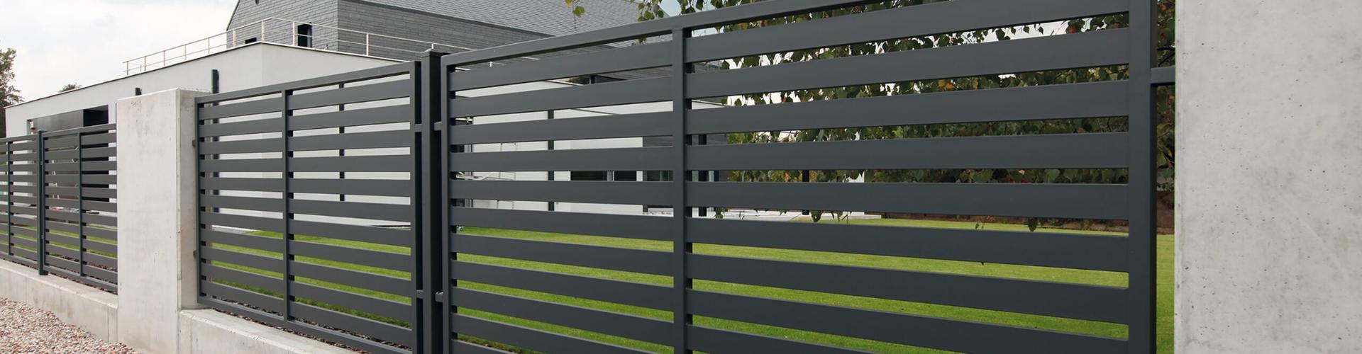 Moderní kovový lamelový plot v antracitové barvě, kombinující elegantní design a vysokou funkčnost pro moderní bydlení.