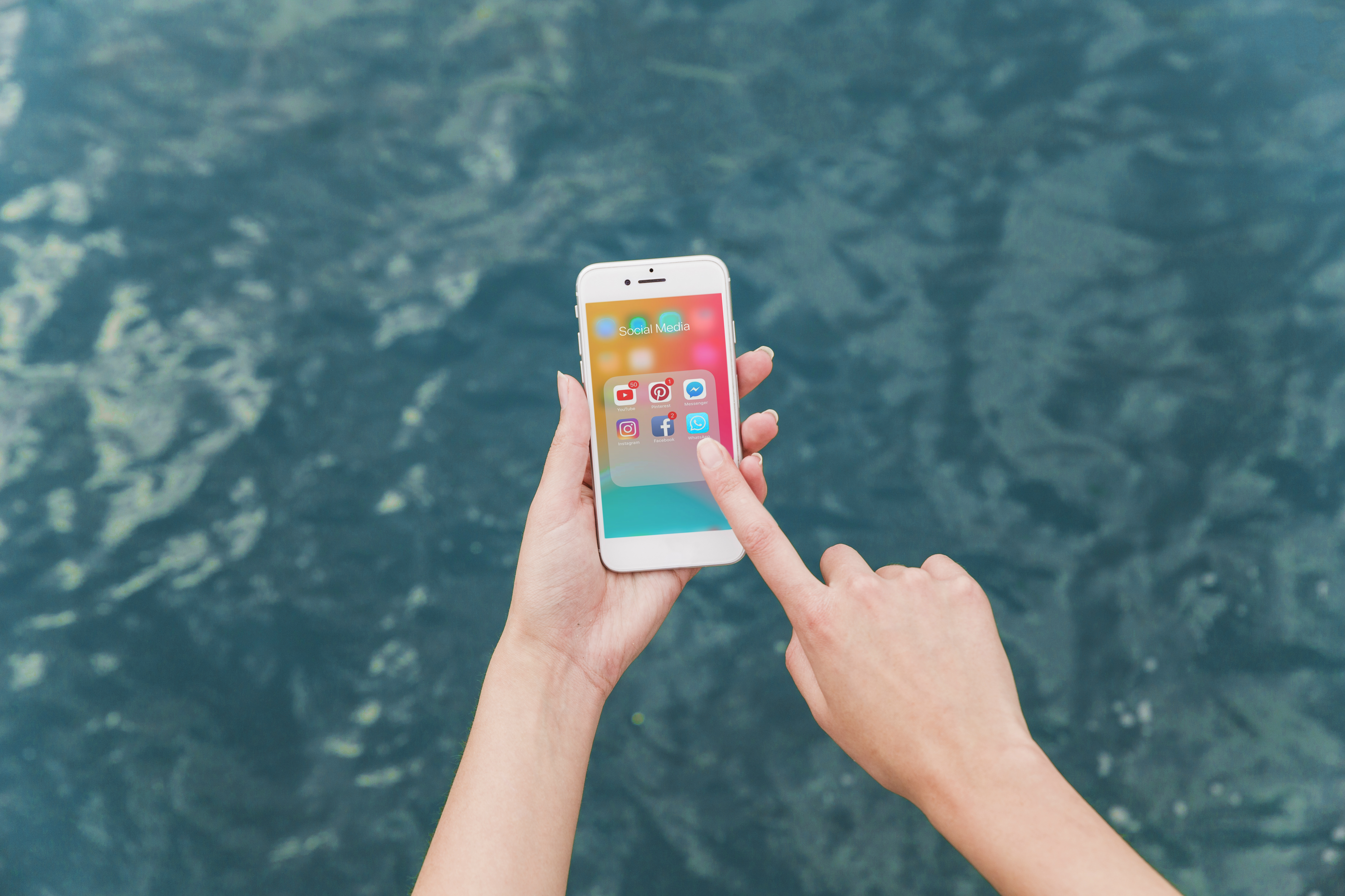 woman-s-hand-using-cellphone-with-social-media-notifications-screen