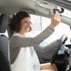 60a82c0ef18a357bcc0804a5 cheerful female car driver looking mirror2