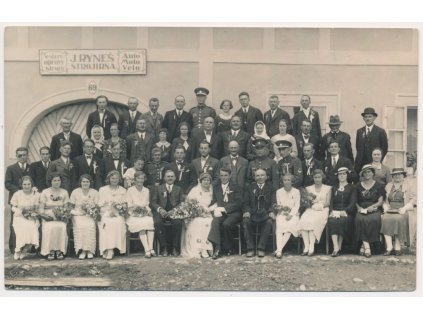 Skupinové foto novomanželů se svatebčany před firmou J. Ryneš-strojírna, cca 1935