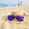 A vibrant summer scene; focus on a pair of purple heart shaped sunglasses casually placed on a woven straw sunhat atop a sandy beach towel, soft pastel colors, late afternoon sunlight casting long shadows, the gent