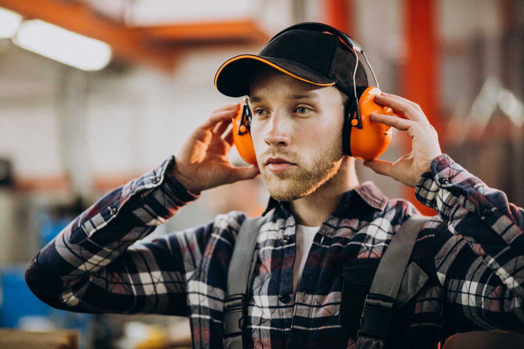 young-male-handyman-with-safety-earphones_1303-22920