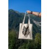 mockup featuring a man s hand holding a tote bag against a natural scenery 3131 el1 (2)