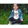 little girl wearing a denim jacket and t shirt mockup in the garden a12098