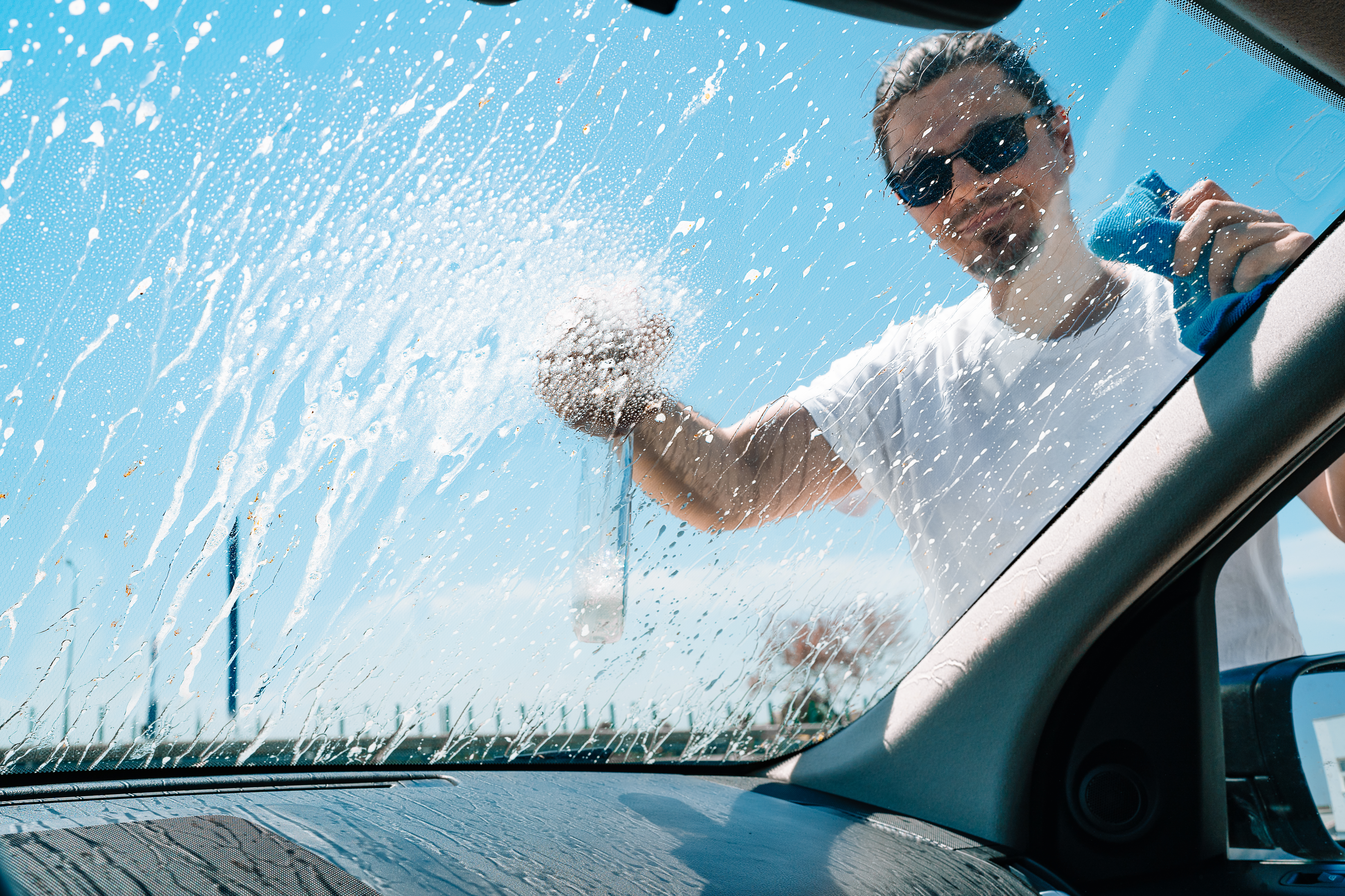 man-washing-car-windshield