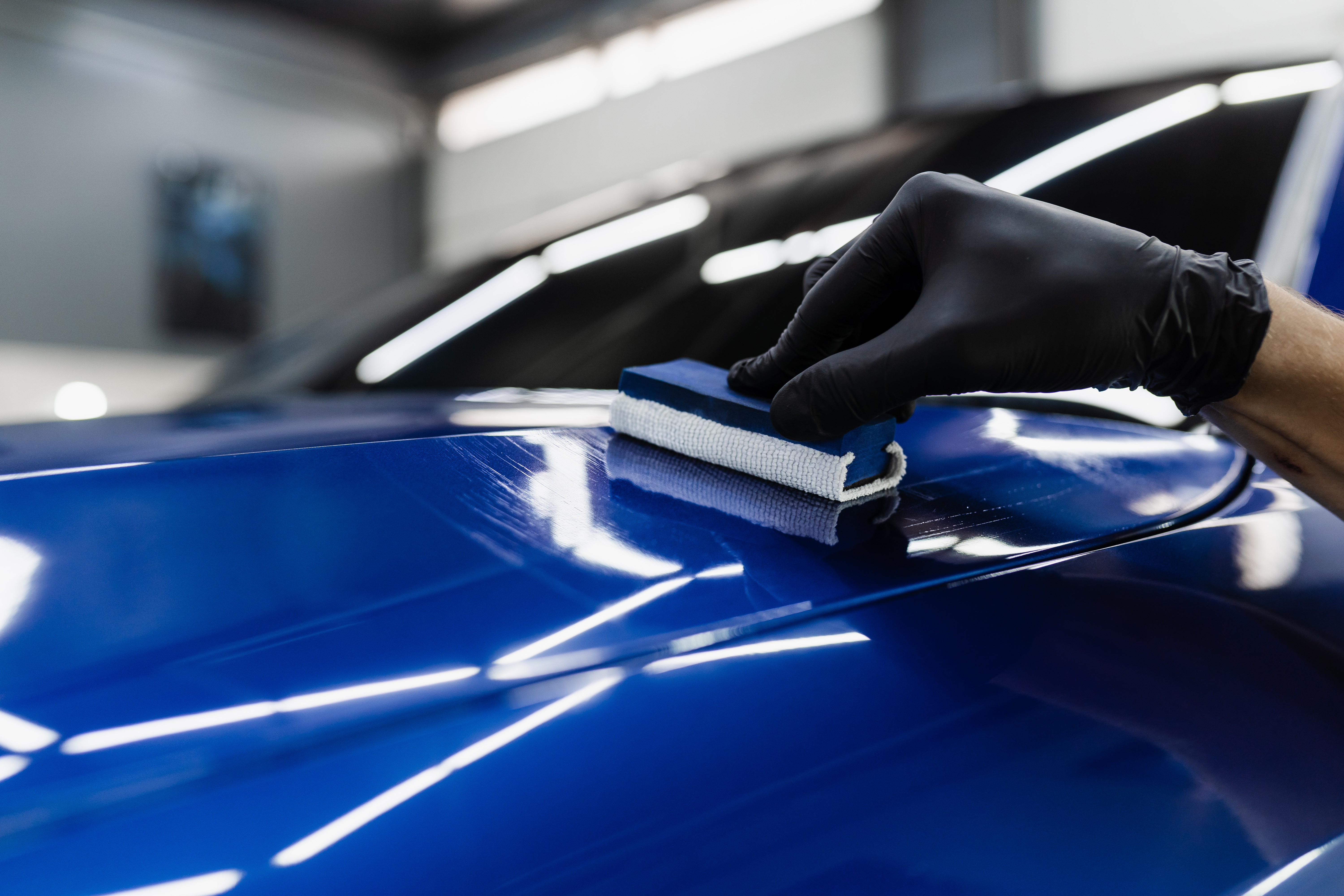 process-applying-ceramic-protective-coat-body-car-detailing-auto-service-car-service-worker-apply-ceramic-coating-protect-car-body-from-scratches