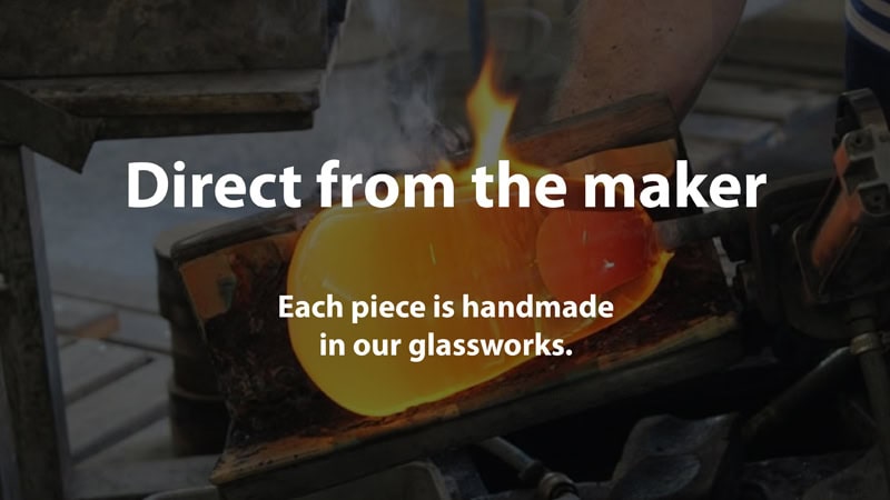 Glassmaker shaping a handmade glass piece in the family glassworks