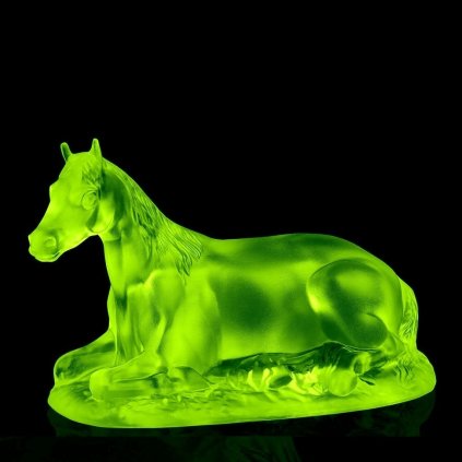 Uranium glass Art Deco reclining horse figurine by H. Hoffmann glowing under UV light