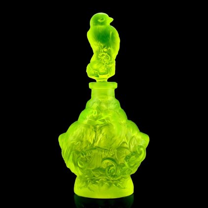1930s Art Deco Bohemian uranium glass perfume bottle with bird stopper glowing bright green under UV light