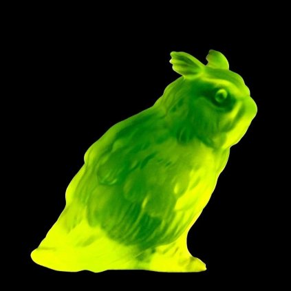Uranium glass Art Deco sitting owl figurine by H. Hoffmann glowing under UV light