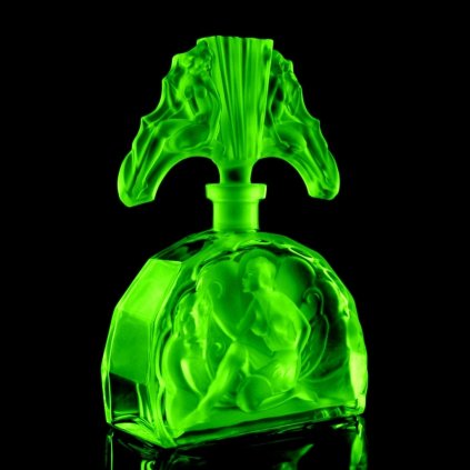 1930s H Hoffmann Art Deco green uranium glass perfume bottle seated lady Lalique-style design glowing under UV light