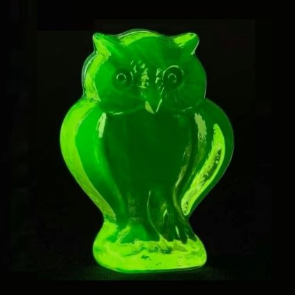 Bohemian uranium glass owl figurine with transparent surface and strong UV glow