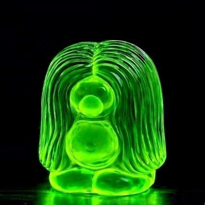 uranium glass troll figurine glowing green under UV light