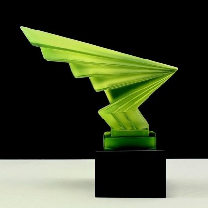 Art Deco lightning hood ornament made of uranium glass on black glass base with strong UV glow