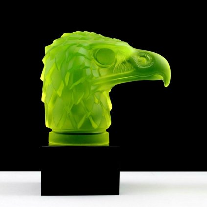 Art Deco eagle head hood ornament in yellow uranium glass with black glass base