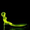 Art Deco uranium glass rectangular basin with seated nude woman glowing under UV light — artdeco1930.com
