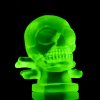 Blue uranium glass Art Deco skull hood ornament showing green UV glow