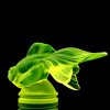 Back view of uranium glass Art Deco fish figurine with vivid UV glow