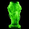 green uranium glass art deco figural vase with nymphs under ultraviolet light