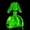 1930s H Hoffmann Art Deco green uranium glass perfume bottle seated lady Lalique-style design glowing under UV light