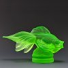 Art Deco fish figurine made of green uranium glass by H. Hoffmann with strong UV glow