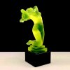 Front view of Art Deco uranium glass nude female hood ornament with black glass base