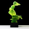 Back view of Art Deco Lovers hood ornament in uranium glass with black glass base showing flowing Art Deco forms