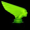 Glowing Art Deco Victoire hood ornament in uranium glass on black glass base under UV light