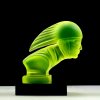 Art Deco racer head hood ornament made of yellow uranium glass on black glass base, Bohemian car mascot