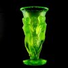 uranium glass tall nymphs vase glowing under uv light, high relief