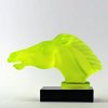 Side view of Art Deco horse head hood ornament in uranium glass mounted on black glass base