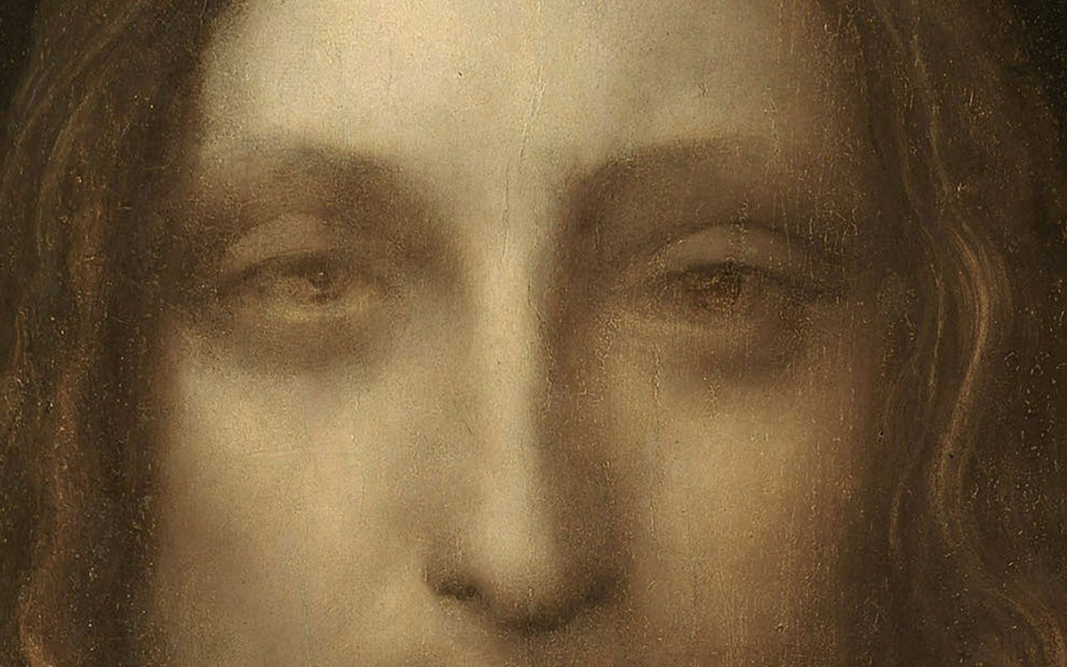 Detail obrazu Salvator Mundi: tvář Krista s měkkými přechody světla a stínu
