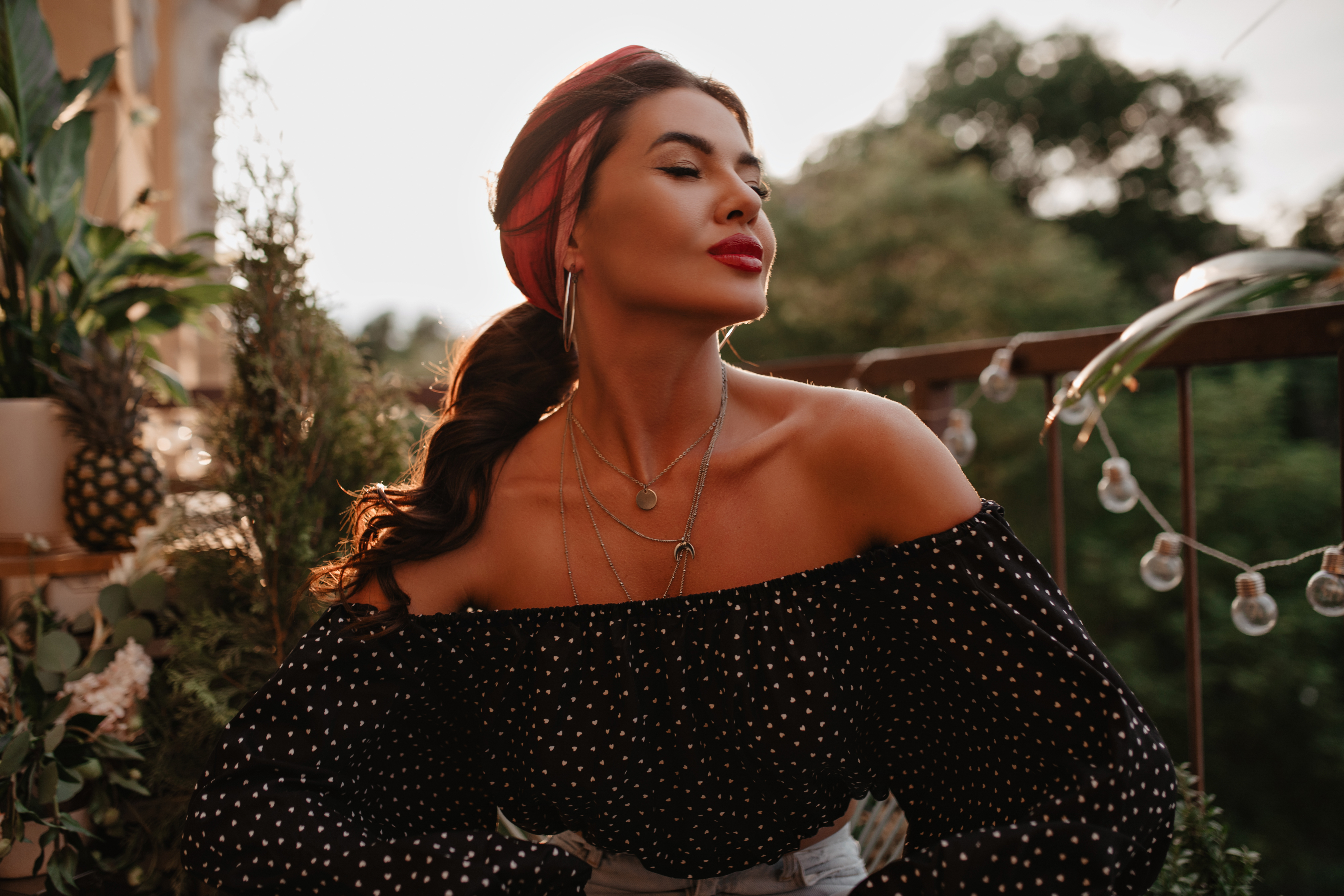 tender-beautiful-girl-with-cool-hairstyle-round-earrings-tender-skin-stylish-black-polka-dot-blouse-posing-with-closed-eyes-balcony