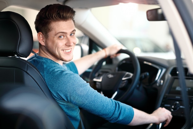 happy-young-male-driver-wheel_136930-4
