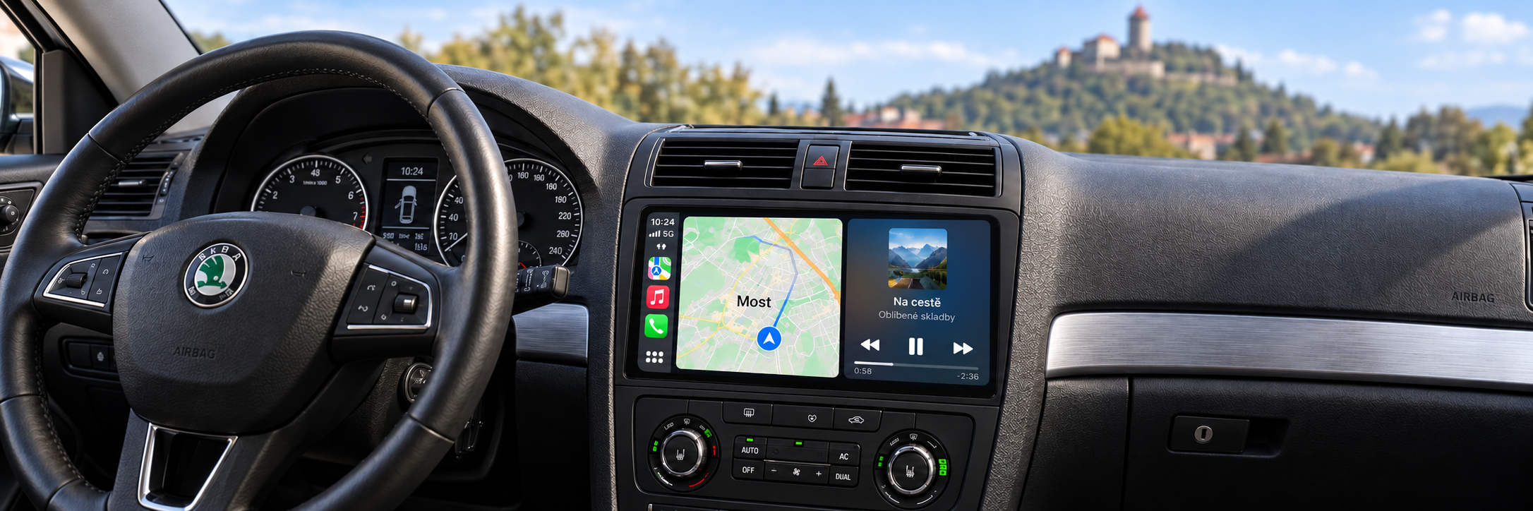 CarPlay s navigací Most a rozmazaným hradem Hněvín v pozadí – ilustrační zobrazení