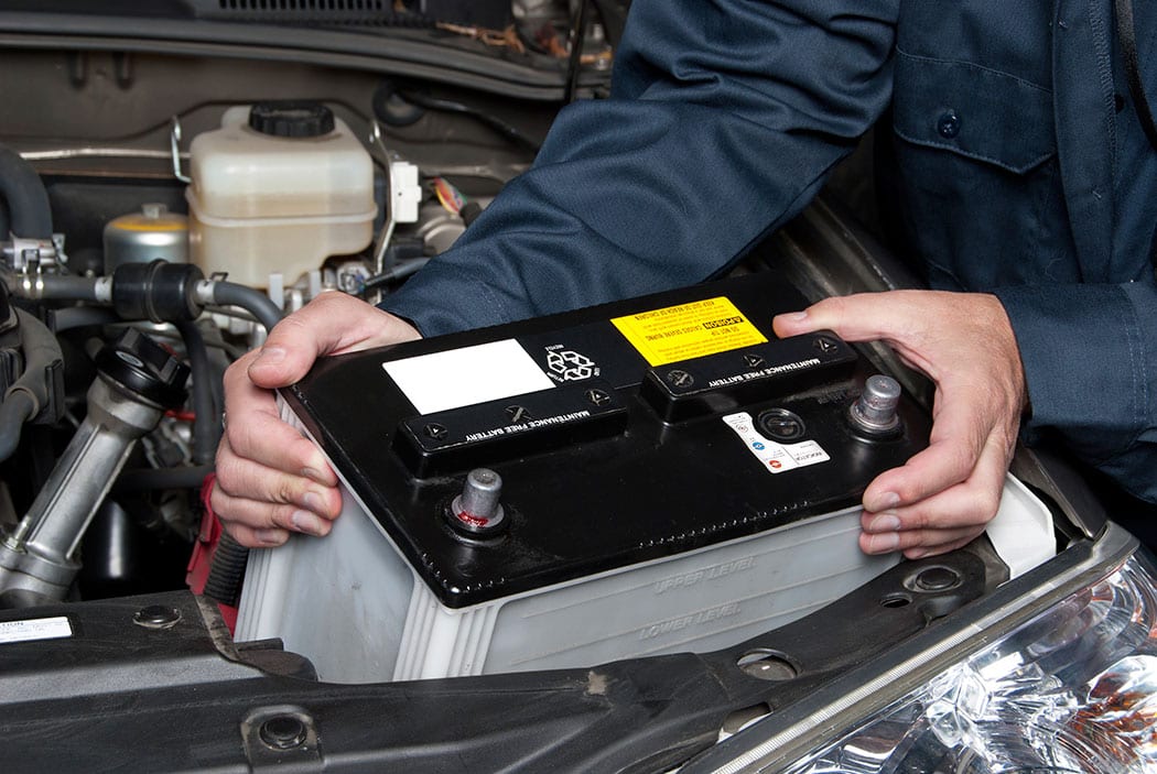 Auto-mechanic-replacing-car-battery