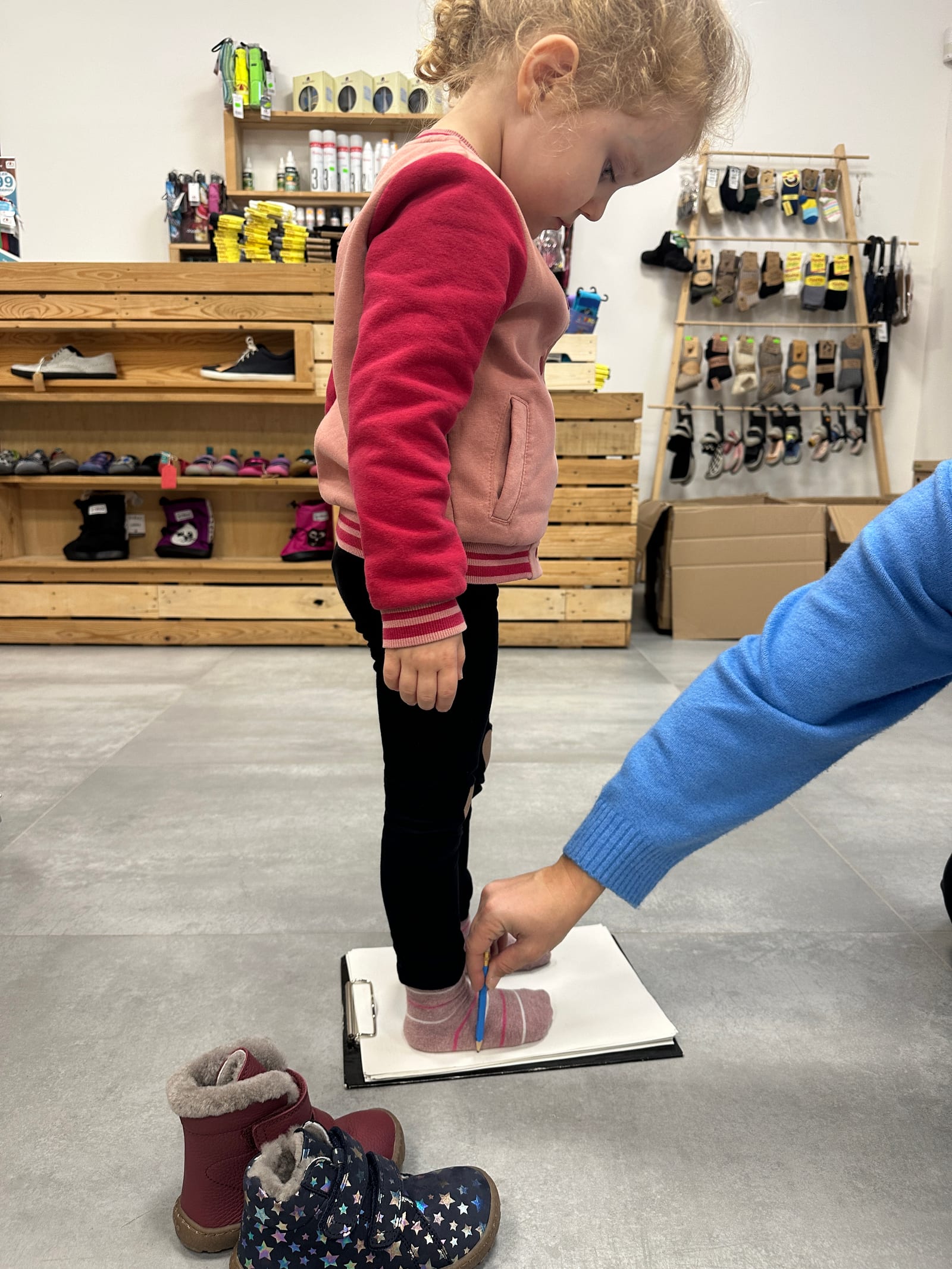 A child's foot being measured for the right barefoot shoe fit
