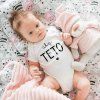 toddler with toy lying bed
