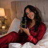 Generated with Kive.ai 27 years old happy chilled lady in red pyjamas in bed holding