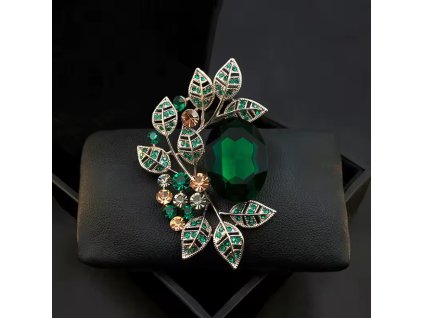 Postříbřená brož s velkým zeleným krystalem a větvičkovými lístky