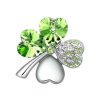 Postříbřená brož ve tvaru čtyřlístku se zelenými krystaly