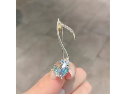 Pozlacená brož ve tvaru noty s krystaly