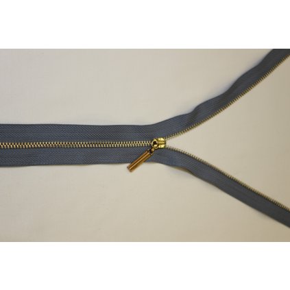 Zip kovový světle šedý se zlatými zoubky