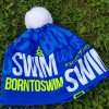 Zimní čepice modrá BornToSwim® se žlutým logem a bílou bambulí