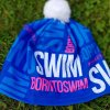 Winter cap blue BornToSwim® with pink logo and white pompom