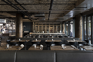  Main part of the restaurant with an open-plan kitchen and a potato storage in the background.